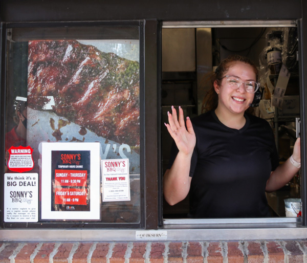 Sonny's BBQ employee waves from drive through